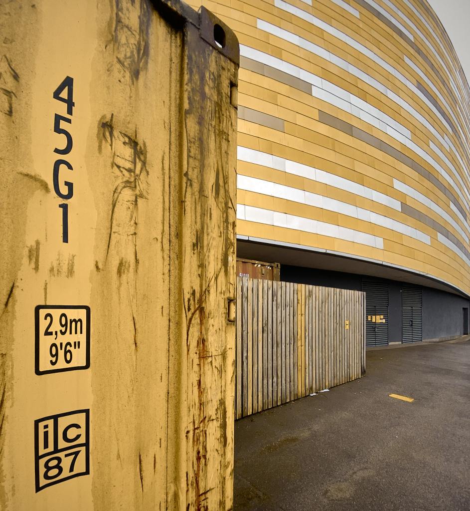 One has to admire the effort taken to blend the new building in with the shipping container.